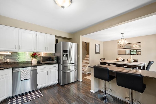 617 Woodcrest Dr, Robinson Twp Nwa, PA 15205 - kitchen with stainless steel appliances, tasteful backsplash, white cabinets, and dark wood-type flooring