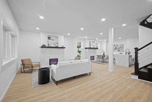 2356 Pittock St, Squirrel Hill, PA 15217 - living area with a premium fireplace, stairs, light wood finished floors, and recessed lighting