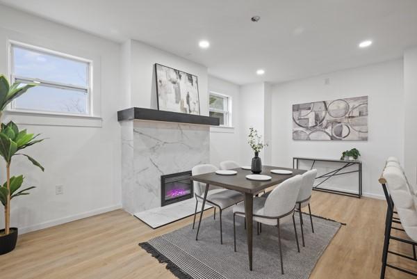 2356 Pittock St, Squirrel Hill, PA 15217 - dining area with light wood-style floors, a fireplace, and recessed lighting