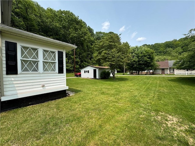 515 Pike Run Dr W, Pike Run Twp, PA 15427 - view of green lawn featuring an outbuilding and a wooded view