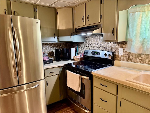 515 Pike Run Dr W, Pike Run Twp, PA 15427 - kitchen with appliances with stainless steel finishes, light countertops, under cabinet range hood, and tasteful backsplash