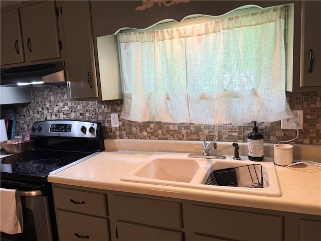 515 Pike Run Dr W, Pike Run Twp, PA 15427 - kitchen with electric range, under cabinet range hood, light countertops, and backsplash