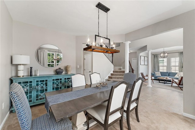 207 Eddie Lewis Dr, Pine Twp Nal, PA 15090 - carpeted dining space with a chandelier, ornate columns, and healthy amount of natural light