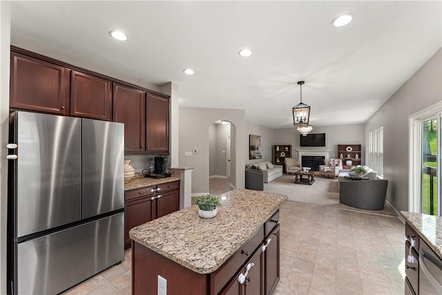 207 Eddie Lewis Dr, Pine Twp Nal, PA 15090 - kitchen with freestanding refrigerator, arched walkways, light stone countertops, recessed lighting, and hanging light fixtures