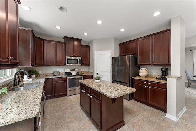 207 Eddie Lewis Dr, Pine Twp Nal, PA 15090 - kitchen featuring appliances with stainless steel finishes, recessed lighting, light stone countertops, a center island, and dark brown cabinetry