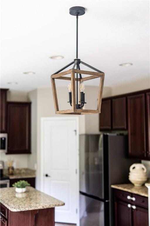 207 Eddie Lewis Dr, Pine Twp Nal, PA 15090 - kitchen with freestanding refrigerator, a chandelier, pendant lighting, light stone countertops, and a kitchen island