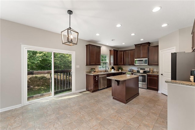207 Eddie Lewis Dr, Pine Twp Nal, PA 15090 - kitchen with stainless steel appliances, dark brown cabinets, recessed lighting, a kitchen island, and light stone counters