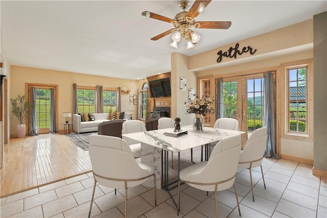 412 Hawthorn Rd, East Finley, PA 15323 - dining room featuring light tile patterned floors, ceiling fan, and a fireplace