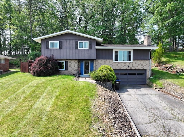 215 Columbia Dr, Center Twp Bea, PA 15001 - tri-level home with a chimney, brick siding, driveway, and an attached garage