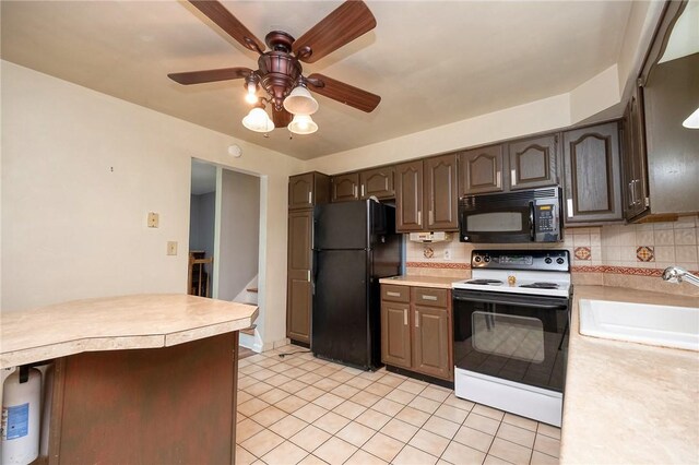 215 Columbia Dr, Center Twp Bea, PA 15001 - kitchen with black appliances, light countertops, ceiling fan, tasteful backsplash, and light tile patterned floors