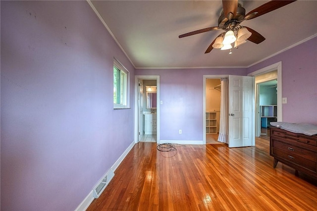 215 Columbia Dr, Center Twp Bea, PA 15001 - unfurnished bedroom with ornamental molding, a walk in closet, light wood finished floors, a closet, and ensuite bathroom