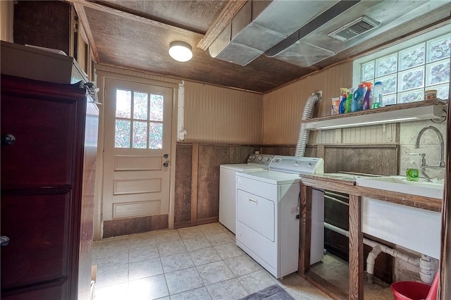 215 Columbia Dr, Center Twp Bea, PA 15001 - laundry area featuring washing machine and dryer, healthy amount of natural light, and wooden walls