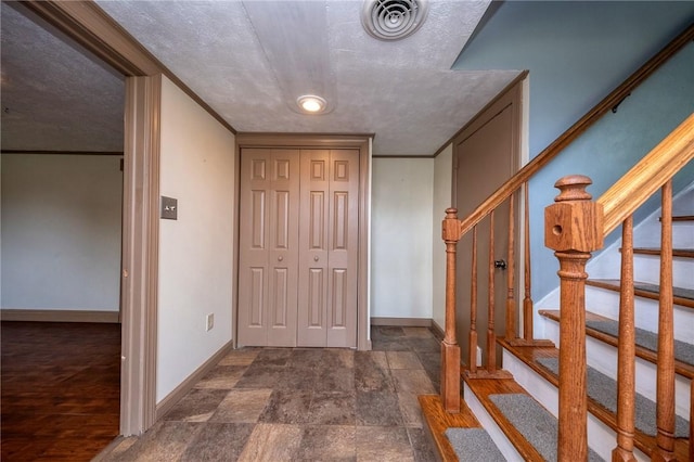215 Columbia Dr, Center Twp Bea, PA 15001 - entryway with stairs, dark stone finish floors, and a textured ceiling