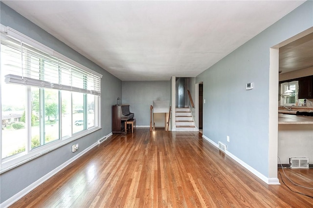 215 Columbia Dr, Center Twp Bea, PA 15001 - unfurnished living room with wood finished floors and stairs