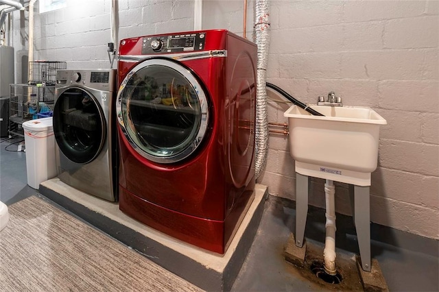 1283 Ashton Rd, Sharon, PA 16146 - laundry area featuring washing machine and dryer, concrete block wall, and water heater