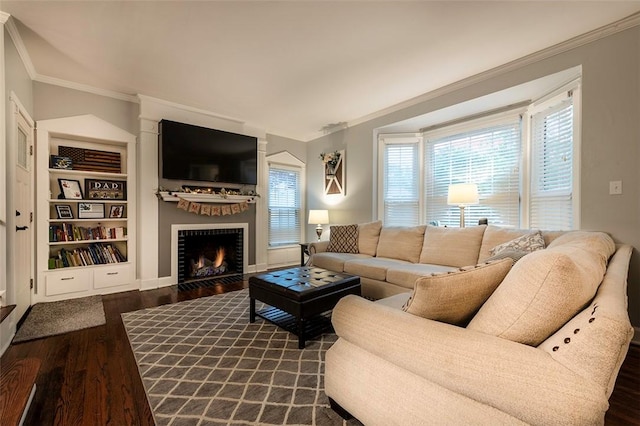 1283 Ashton Rd, Sharon, PA 16146 - living room featuring dark wood-style flooring, ornamental molding, a lit fireplace, and built in features