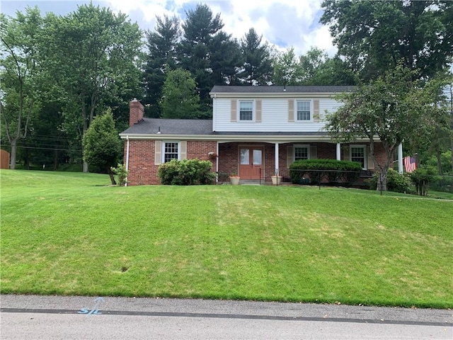 107 Fenwick Dr, Ross Twp, PA 15237 - traditional-style house with brick siding, a front yard, a chimney, and covered porch