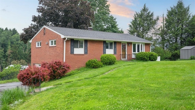108 Tanglewood Dr, Middlesex Twp, PA 16059 - single story home with a front yard, brick siding, a storage shed, and a chimney