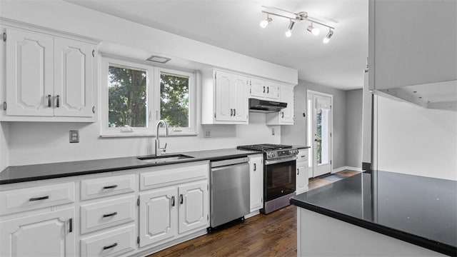 108 Tanglewood Dr, Middlesex Twp, PA 16059 - kitchen with appliances with stainless steel finishes, dark countertops, under cabinet range hood, and white cabinets