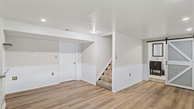 108 Tanglewood Dr, Middlesex Twp, PA 16059 - finished basement with wainscoting, wood finished floors, stairway, a barn door, and recessed lighting