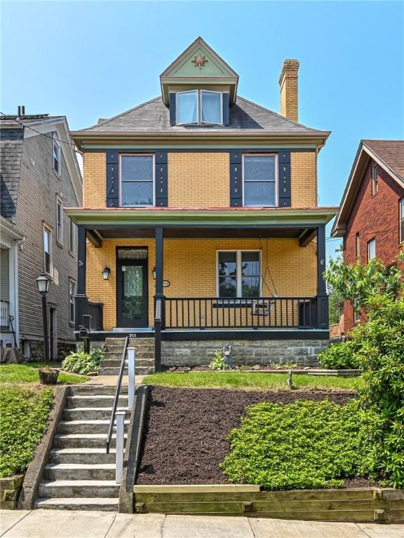 711 Klemont Ave, Ross Twp, PA 15202 - traditional style home with brick siding, a chimney, covered porch, and stairs