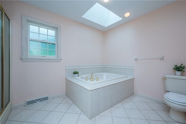 221 William Dr, North Strabane, PA 15317 - bathroom with a garden tub, a skylight, tile patterned floors, and an enclosed shower