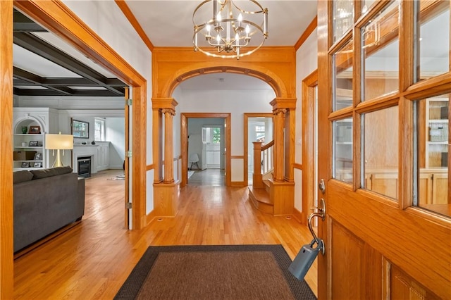 1463 Beechwood Blvd, Squirrel Hill, PA 15217 - entrance foyer with arched walkways, light wood-style flooring, a chandelier, ornamental molding, and a fireplace