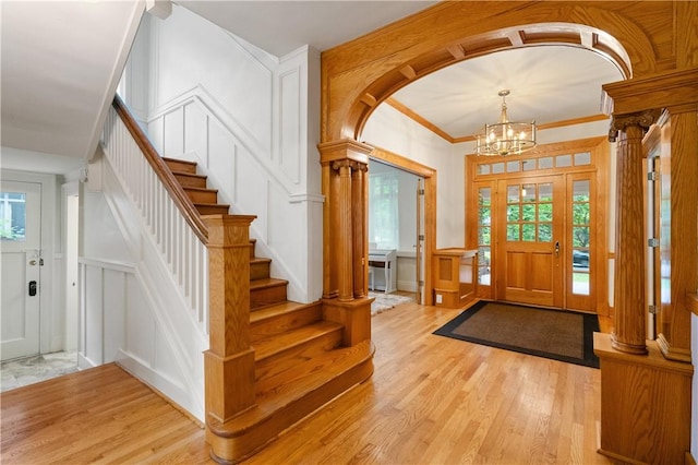 1463 Beechwood Blvd, Squirrel Hill, PA 15217 - foyer entrance featuring a decorative wall, a chandelier, light wood finished floors, arched walkways, and stairway