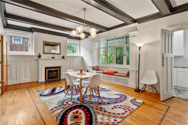 1463 Beechwood Blvd, Squirrel Hill, PA 15217 - dining space with light wood-type flooring, beam ceiling, a fireplace with flush hearth, and a chandelier