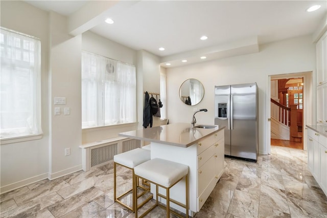 1463 Beechwood Blvd, Squirrel Hill, PA 15217 - kitchen with stainless steel refrigerator with ice dispenser, radiator, white cabinets, recessed lighting, and a kitchen island with sink