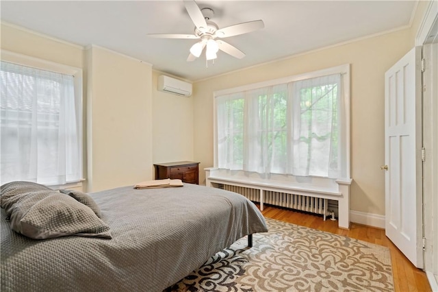 1463 Beechwood Blvd, Squirrel Hill, PA 15217 - bedroom with a wall unit AC, radiator, light wood-type flooring, crown molding, and a ceiling fan
