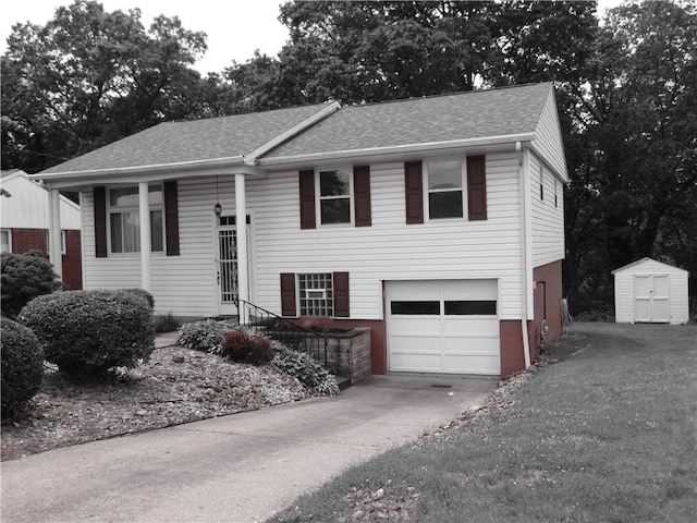127 Louis Dr, Stowe Twp, PA 15136 - view of front of house with driveway, an attached garage, a storage shed, and a shingled roof