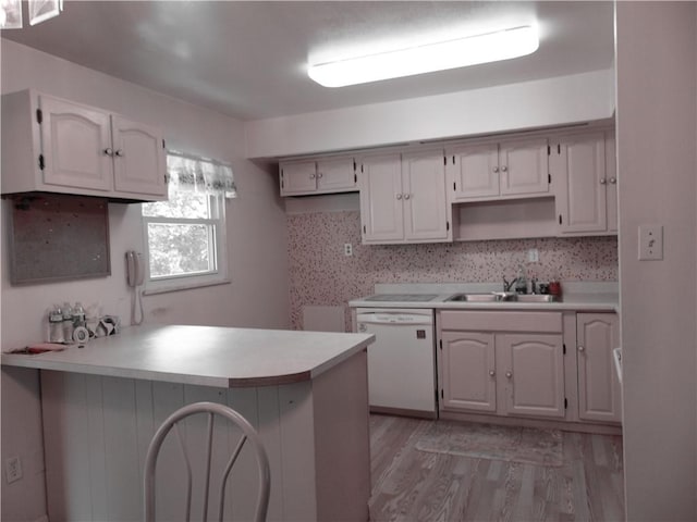 127 Louis Dr, Stowe Twp, PA 15136 - kitchen with white dishwasher, a peninsula, light wood-type flooring, and light countertops