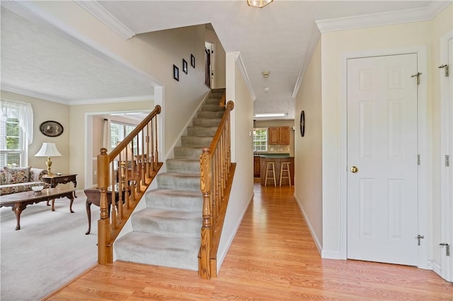 6032 Hawthorn Dr, Moon/Crescent Twp, PA 15108 - stairs with plenty of natural light, wood finished floors, and ornamental molding