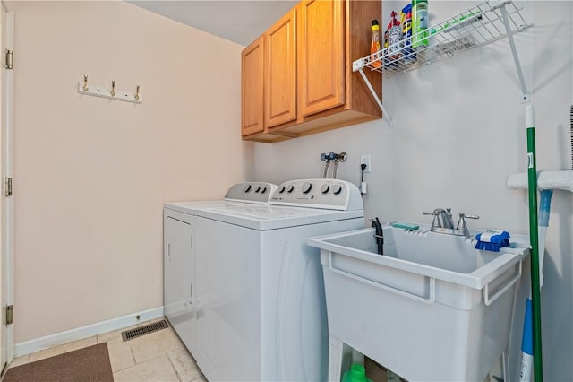 6032 Hawthorn Dr, Moon/Crescent Twp, PA 15108 - laundry room with washing machine and dryer, cabinet space, and light tile patterned floors