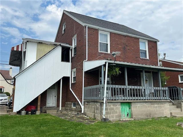 2864 Leechburg Rd, Lower Burrell, PA 15068 - back of property featuring a porch, brick siding, and a yard