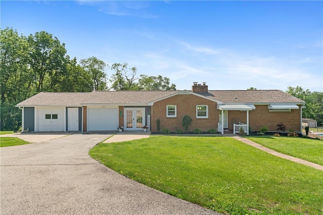 160 Sonnie Dr, Salem Twp Wml, PA 15624 - ranch-style home featuring french doors, a front lawn, asphalt driveway, and brick siding