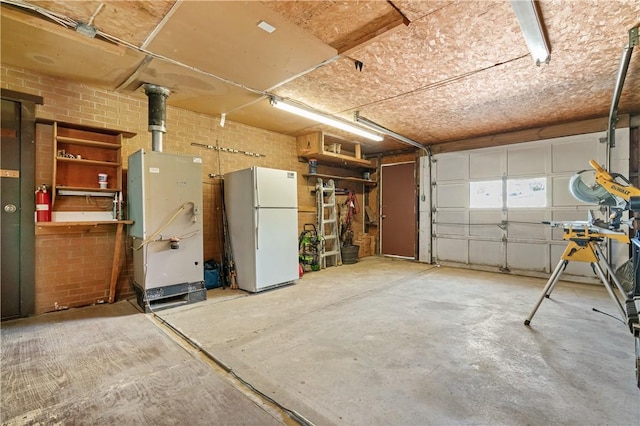 160 Sonnie Dr, Salem Twp Wml, PA 15624 - garage with freestanding refrigerator and heating unit