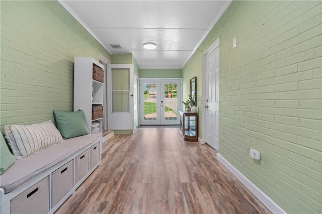 160 Sonnie Dr, Salem Twp Wml, PA 15624 - mudroom featuring french doors, wood finished floors, brick wall, and ornamental molding