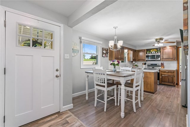 160 Sonnie Dr, Salem Twp Wml, PA 15624 - dining space with a chandelier, light wood-style floors, a ceiling fan, and beamed ceiling