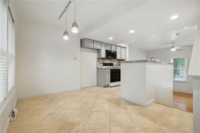 1606 Merriman Ct, South Side, PA 15203 - kitchen featuring white gas range, gray cabinetry, stainless steel microwave, tasteful backsplash, and a ceiling fan