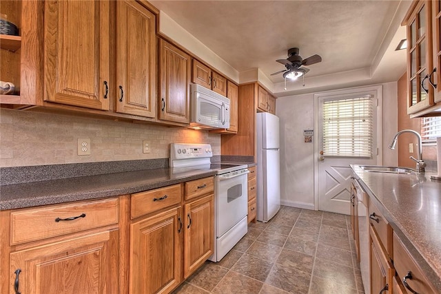 712 N 2nd St, Jeannette, PA 15644 - kitchen featuring white appliances, a ceiling fan, dark countertops, and tasteful backsplash
