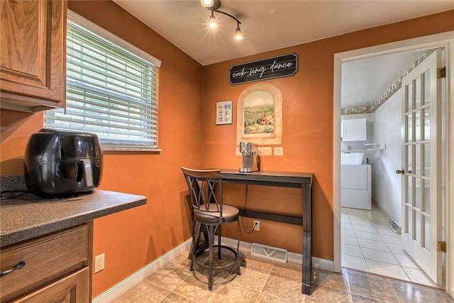 712 N 2nd St, Jeannette, PA 15644 - dining space with washer / dryer, light tile patterned floors, and track lighting