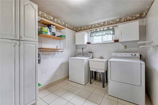 712 N 2nd St, Jeannette, PA 15644 - washroom with cabinet space, washing machine and dryer, and light tile patterned floors
