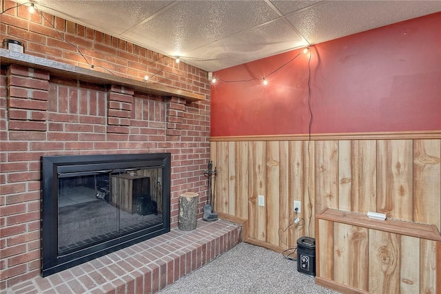 712 N 2nd St, Jeannette, PA 15644 - detailed view of a fireplace, wainscoting, carpet floors, and wooden walls