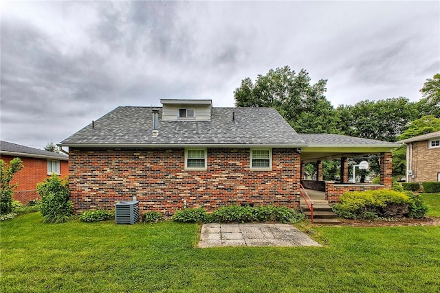712 N 2nd St, Jeannette, PA 15644 - rear view of property featuring brick siding, a lawn, a shingled roof, and a patio