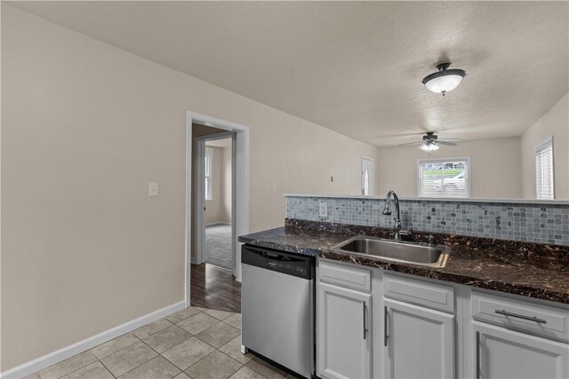 2960 Brevard Ave, Brentwood, PA 15227 - kitchen with dishwasher, ceiling fan, backsplash, light tile patterned floors, and white cabinetry
