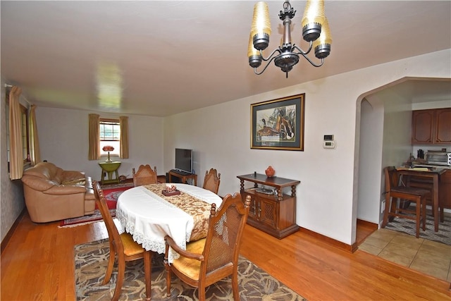 104 Sherwick Dr, Elizabeth Twp/Boro, PA 15037 - dining area with a chandelier, arched walkways, and light wood finished floors