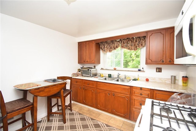 104 Sherwick Dr, Elizabeth Twp/Boro, PA 15037 - kitchen with white microwave, light countertops, brown cabinetry, and stove