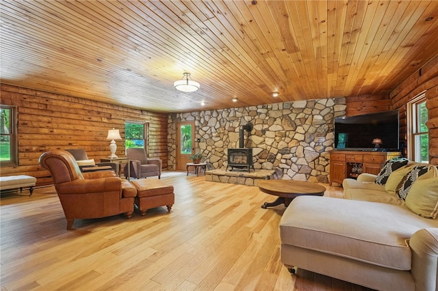 125 Timber Ridge Rd, Clinton Twp, PA 16056 - living area with wood ceiling, log walls, a wood stove, light wood-style flooring, and healthy amount of natural light